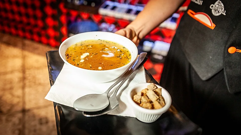 Garlic soup česnečka served by a waiter – Dřevný Kocúr